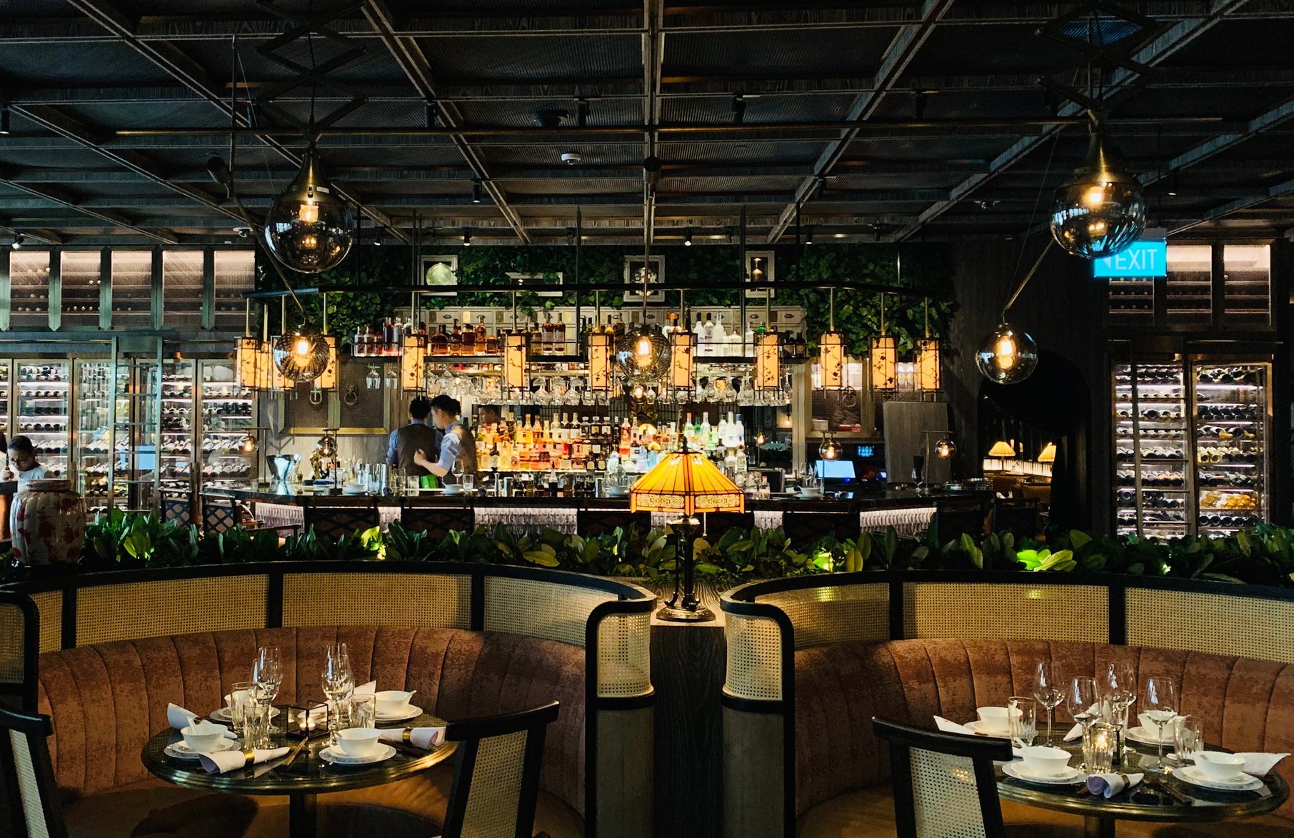 Interior of modern restaurant with round tables and comfy sofas